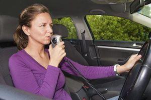 Woman using ignition interlock device